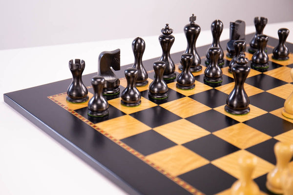 Vintage wooden chess set with queen gambit opening, close-up view