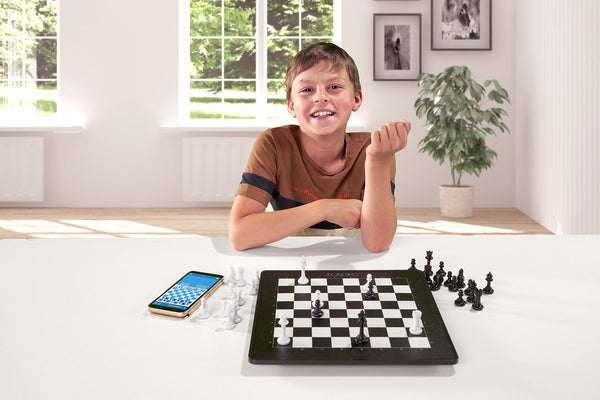 Kid Boy With Glasses Playing Online Chess Board Game On Computer