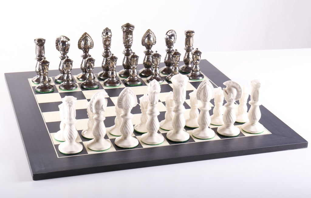At Auction: A large ornate chess set with sterling silver board. Board  measures 46x46x8cm